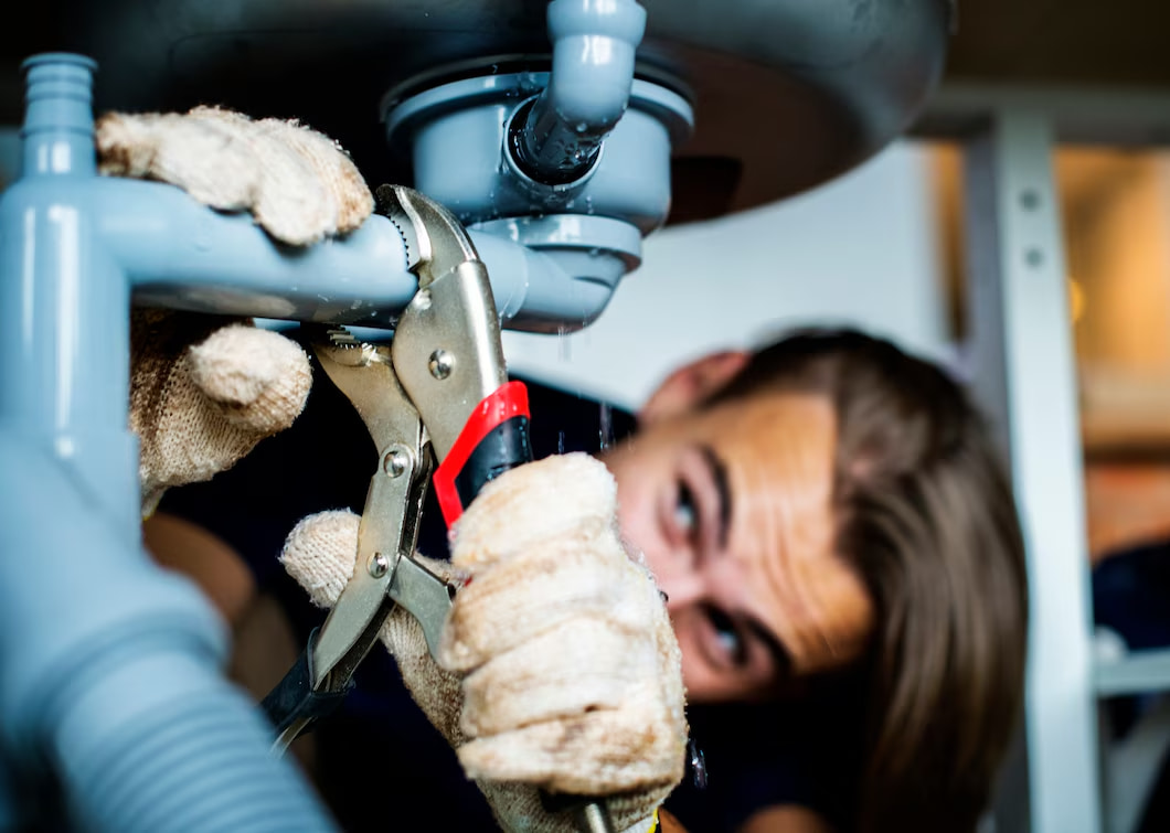 man-fixing-kitchen-sink_53876-13430