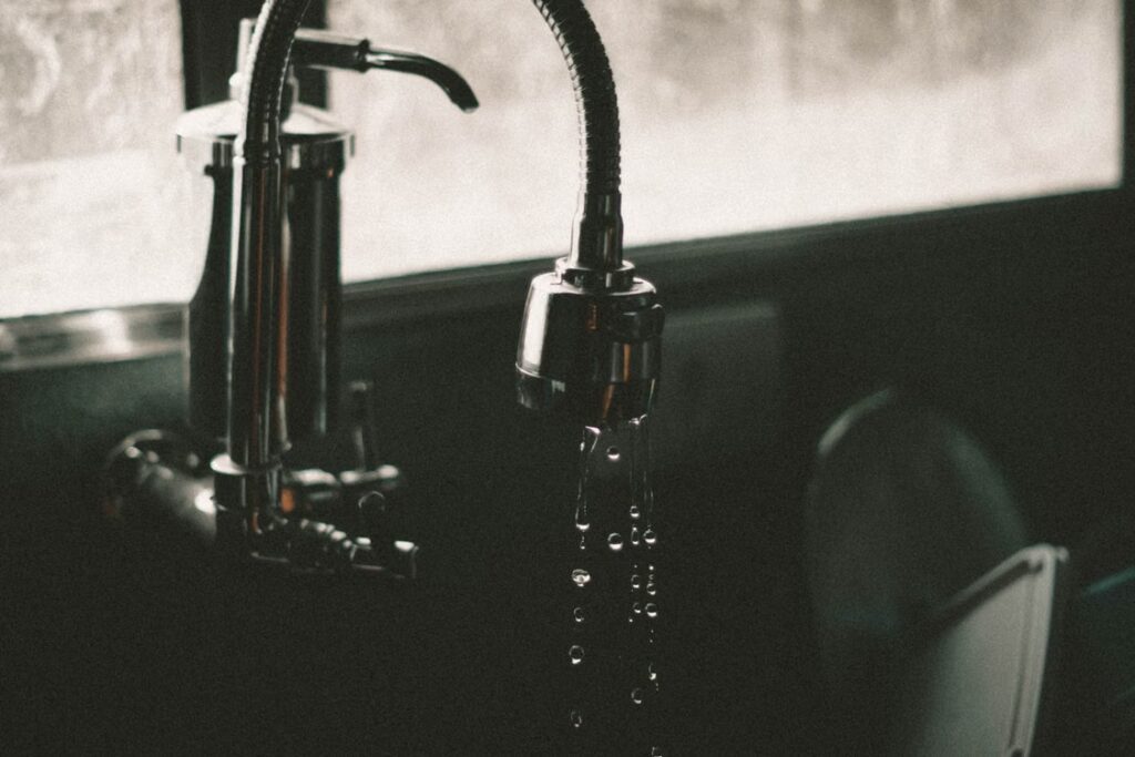 A faucet leaking water with plumbing problems
